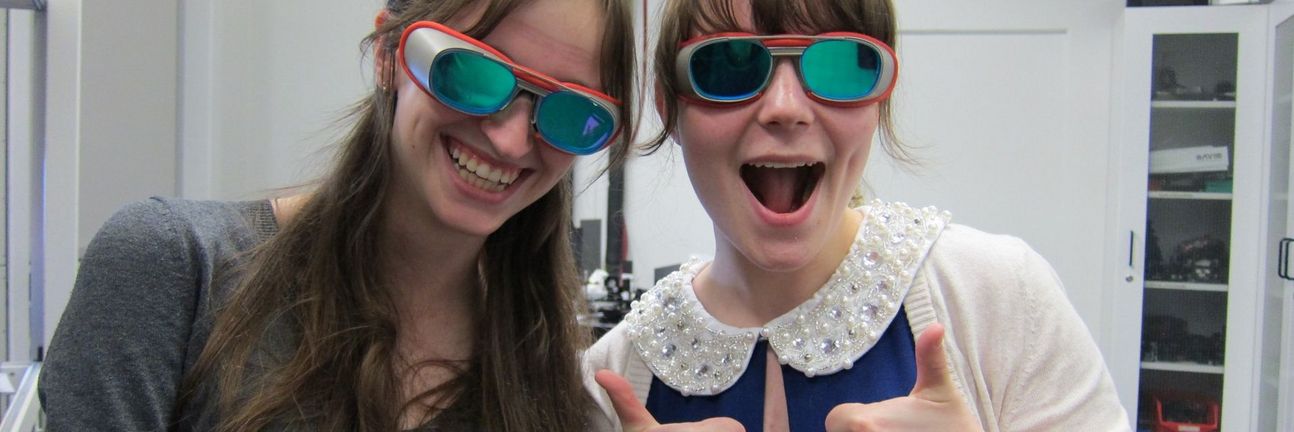 two students with laser protection goggles.